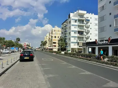 a car parked on the side of a street with buildings at 16 SANDY BEACH in Larnaka