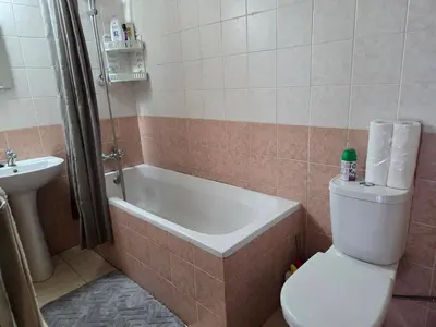 a bathroom with a toilet and a tub and a sink at One Bedroom aptm Larnaca in Larnaka