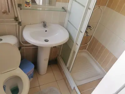 a small bathroom with a sink and a toilet at Nicosia rooms Studios in Nicosia