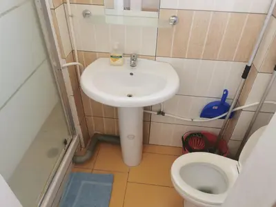a small bathroom with a sink and a toilet at Nicosia rooms Studios in Nicosia