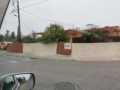 a side view mirror of a car driving down a street at Nicosia rooms Studios in Nicosia