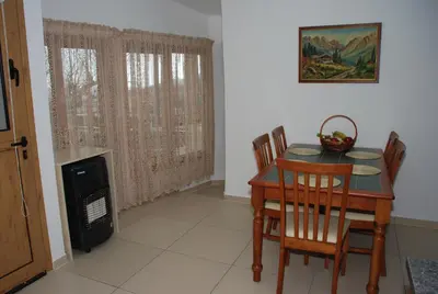 a dining room with a table and chairs and a fireplace at Kanarinis House in Omodos