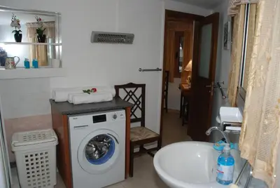 a bathroom with a washing machine and a sink at Kanarinis House in Omodos