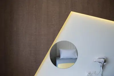 a mirror with a pillow in a room at Narcissos Waterpark Resort in Protaras