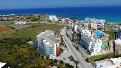 an aerial view of a city and the ocean at The Blue Ivy Hotel & Suites in Protaras