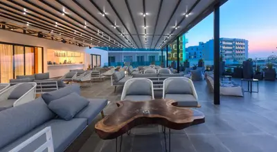 a living room with couches and chairs and a table at The Blue Ivy Hotel & Suites in Protaras