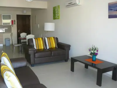 a living room with a couch and a coffee table at Pyla Gardens E107 in Pyla