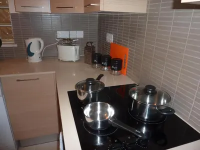 a kitchen with pots and pans on a stove at Pyla Gardens E107 in Pyla