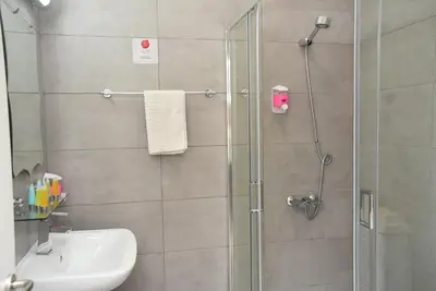 a bathroom with a shower and a sink at Rimon Cyprus Israeli Kosher Rooms in Larnaka