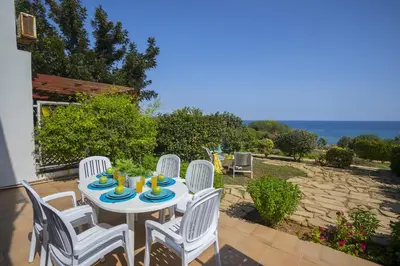 a white table and chairs on a patio at Protaras Beachfront Sirina Lina Suite in Paralimni