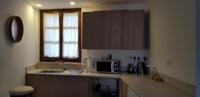 a kitchen with a sink and a microwave at Kalopanayiotis Museum Inn in Kalopanayiotis