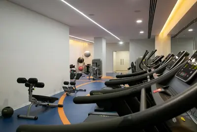 a gym with rows of exercise bikes and treadmills at Vangelis Hotel & Suites in Protaras
