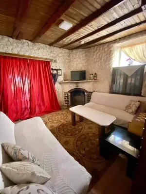 a living room with a white couch and a fireplace at Saint Nicholas heights in Chakistra