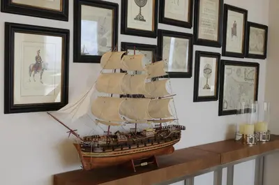 a wooden model of a ship on a wall with pictures at E-Hotel Larnaca Resort & Spa in Larnaka