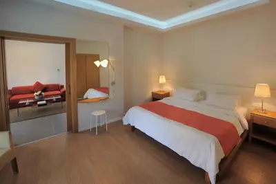 a hotel room with a large bed and a mirror at E-Hotel Larnaca Resort & Spa in Larnaka