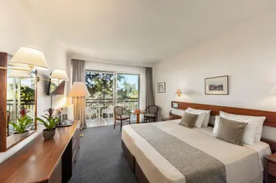 a hotel room with a bed and a large window at Forest Park Hotel in Platres