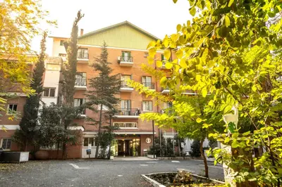 a building with a parking lot in front of it at Forest Park Hotel in Platres