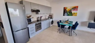 a kitchen with a table and a refrigerator at Mazotos Hills 3 in Mazotos