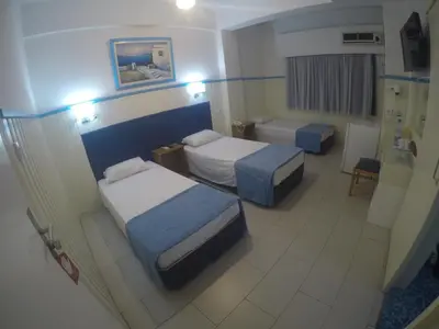 a hotel room with two beds and a bathroom at Asty Hotel in Nicosia