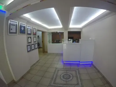 a hallway with an arch in a room with a kitchen at Asty Hotel in Nicosia