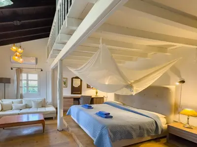 a bedroom with a bed with a mosquito net at Kalavasos Square Apartments - With Access to Shared Pool 3 Minutes Walk in Kalavasos