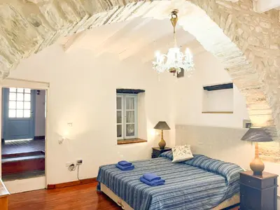 a bedroom with a large bed in a room at Kalavasos Square Apartments - With Access to Shared Pool 3 Minutes Walk in Kalavasos