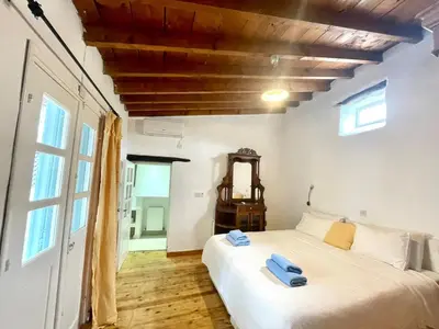 a bedroom with a bed with blue towels on it at Kalavasos Square Apartments - With Access to Shared Pool 3 Minutes Walk in Kalavasos