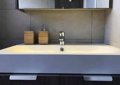 a bathroom sink with a faucet on top of it at Metro Court Apartments in Limassol