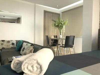 a living room with a couch and a table with chairs at Metro Court Apartments in Limassol