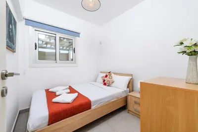 a bedroom with a bed with two towels on it at Ayia Triada View in Protaras