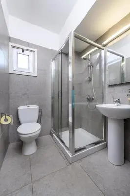 a bathroom with a shower and a toilet and a sink at Ayia Triada View in Protaras