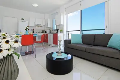 a living room with a couch and a kitchen at Apartment Erika in Protaras