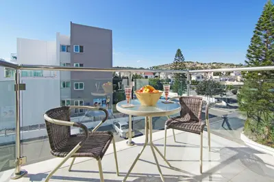 a table and chairs on a balcony with a view at Amber - Coralli Beachfront Apartment in Protaras