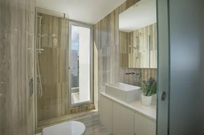 a bathroom with a sink and a toilet and a mirror at Protaras Villa Zen in Protaras