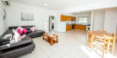 a living room with a couch and a table at Villa Stefanie in Ayia Napa
