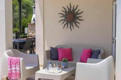a living room with a couch and a table at Villa Mesogeios 39 in Paralimni