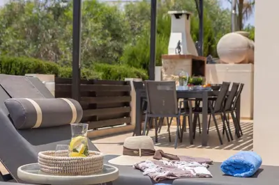 a patio with a table and a table and chairs at Villa Mesogeios 39 in Paralimni