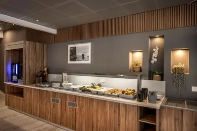 a buffet line in a hotel with food on it at Lantiana Gardens ApartHotel in Protaras