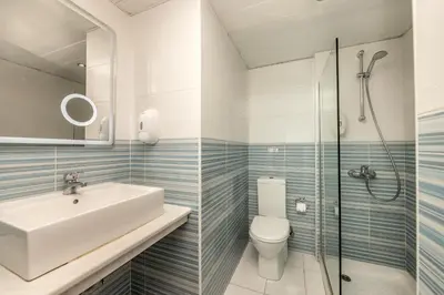 a bathroom with a sink and a toilet and a shower at Lantiana Gardens ApartHotel in Protaras