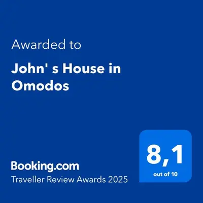 a blue text box with the words awarded to johanns house in am at John' s House in Omodos in Limassol