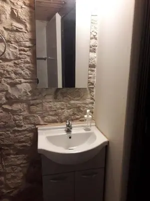 a bathroom with a sink and a mirror at John' s House in Omodos in Limassol