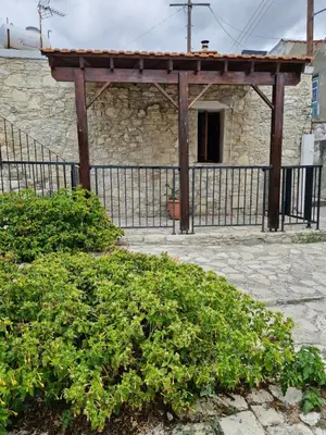an old building with a gate and a fence at John' s House in Omodos in Limassol