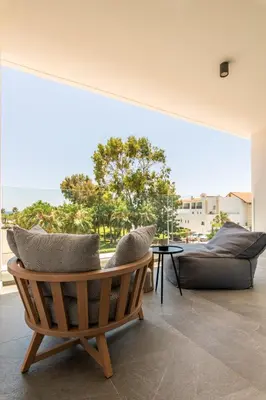 a living room with a couch and a chair at Abacus Suites in Ayia Napa