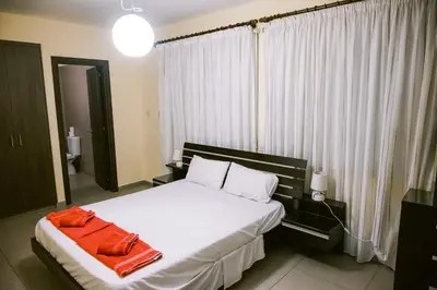 a bedroom with a bed with a red towel on it at Villa Costa Cornelia Homes in Ayia Napa