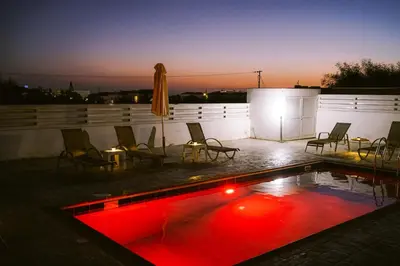 a swimming pool with red lights on a roof at Villa Costa Cornelia Homes in Ayia Napa