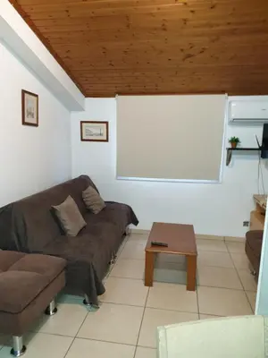 a living room with a couch and a table at Strovolos rooms Studios in Nicosia