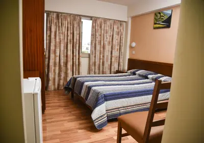 a hotel room with a bed and a window at Elysso Hotel in Larnaka