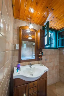 a bathroom with a sink and a mirror at Themis House in Lemithou