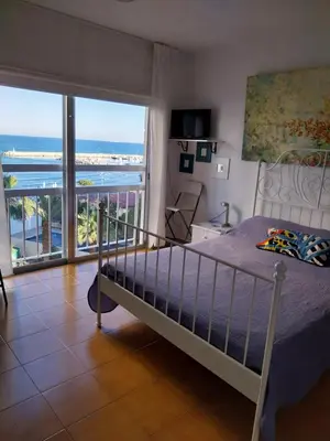 a bedroom with a bed and a view of the ocean at MIKIS's SeaGate Studio Aprt. in Larnaka