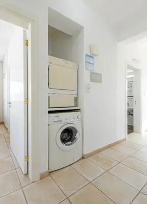 a washer and dryer in a white room at Sunrise Bay Villa #1 in Paralimni